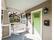 The covered front porch features a porch swing, bright green front door, and decorative sconces at 1513 Pinecrest Pl, Orlando, FL 32803