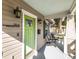 Cozy covered front porch area with outdoor seating and views of a landscaped front yard at 1513 Pinecrest Pl, Orlando, FL 32803