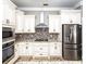 Close up of kitchen featuring stainless steel appliances and stylish backsplash at 1513 Pinecrest Pl, Orlando, FL 32803