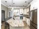 Sunlit kitchen boasts granite counters, stainless appliances, and white cabinets at 1513 Pinecrest Pl, Orlando, FL 32803