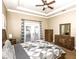 Spacious primary bedroom boasts a decorative tray ceiling and access to the backyard at 1513 Pinecrest Pl, Orlando, FL 32803