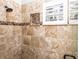 A luxurious shower featuring decorative tiles, built in niche, and window shutter at 1513 Pinecrest Pl, Orlando, FL 32803