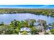 Gorgeous aerial view of expansive lakeside estate featuring mature trees, private boat dock, and serene waterfront ambiance at 1532 Lake Shore Dr, Orlando, FL 32803