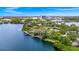 Aerial view of the home and lake featuring a waterfront community with lush landscaping at 1532 Lake Shore Dr, Orlando, FL 32803