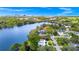 Stunning aerial view of lakeside home with lush greenery, waterfront access, and city skyline in the background at 1532 Lake Shore Dr, Orlando, FL 32803