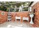 Unique atrium with glass ceiling, brick walls, and white wicker furniture creates a bright and airy ambiance at 1532 Lake Shore Dr, Orlando, FL 32803