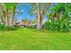Expansive backyard featuring lush lawn, mature trees, and a serene outdoor setting at 1532 Lake Shore Dr, Orlando, FL 32803