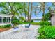 Backyard patio with table and chairs overlooking lush landscaping and waterfront view at 1532 Lake Shore Dr, Orlando, FL 32803