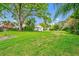 Expansive, grassy backyard with mature trees and landscaping at 1532 Lake Shore Dr, Orlando, FL 32803