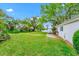 Lush backyard offering a large grassy area and access to waterfront views at 1532 Lake Shore Dr, Orlando, FL 32803