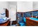 Bathroom featuring blue tiles, vintage sink and toilet with contrasting dark brown accents at 1532 Lake Shore Dr, Orlando, FL 32803