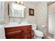 Updated bathroom featuring vanity, mirror, toilet and shower/tub combination and neutral wall paper at 1532 Lake Shore Dr, Orlando, FL 32803