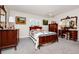 Spacious bedroom featuring carpet, ceiling fan, natural light, vintage furniture and neutral paint color at 1532 Lake Shore Dr, Orlando, FL 32803
