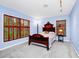 Charming bedroom with hardwood furniture, blue walls, and large windows with wood shutters at 1532 Lake Shore Dr, Orlando, FL 32803