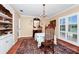 Traditional dining room with chandelier, hard wood floors, and large windows provide ample natural light at 1532 Lake Shore Dr, Orlando, FL 32803