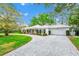 Home exterior featuring a white exterior, paved driveway, and an attached garage at 1532 Lake Shore Dr, Orlando, FL 32803