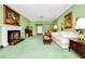 A classic living room with a fireplace, green walls, and traditional furnishings at 1532 Lake Shore Dr, Orlando, FL 32803
