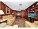 Cozy living room featuring wood paneling, built-in shelves, and comfortable seating at 1532 Lake Shore Dr, Orlando, FL 32803