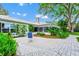 Outdoor patio featuring patterned pavers, lush tropical landscaping and a tranquil garden setting at 1532 Lake Shore Dr, Orlando, FL 32803