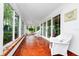Charming sunroom with ample windows, tiled floor, and wicker seating; the perfect indoor/outdoor room at 1532 Lake Shore Dr, Orlando, FL 32803