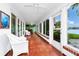 Spacious sunroom featuring multiple windows with scenic views and access to the home's interior and exterior at 1532 Lake Shore Dr, Orlando, FL 32803