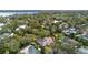 A neighborhood aerial view showcases the lake and mature greenery surrounding the residences at 1600 Barcelona Way, Winter Park, FL 32789