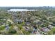 An elevated neighborhood view reveals a lush setting with a lake and mature landscaping around homes at 1600 Barcelona Way, Winter Park, FL 32789