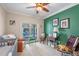 Bright Bedroom with a view of the pool, featuring a crib, rocking chair, and green accent wall at 1600 Barcelona Way, Winter Park, FL 32789