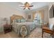 Cozy bedroom featuring a floral-patterned bed, window seat, and decorative rug at 1600 Barcelona Way, Winter Park, FL 32789