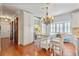 Dining area with white cabinets, hardwood floors, and a large bay window at 1600 Barcelona Way, Winter Park, FL 32789