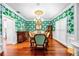 Bright dining room with hardwood floors, decorative wallpaper, and elegant wood trim at 1600 Barcelona Way, Winter Park, FL 32789