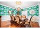 Elegant dining room featuring hardwood floors, decorative wallpaper, and a classic chandelier at 1600 Barcelona Way, Winter Park, FL 32789