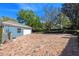 Wide brick-paved driveway leading to a blue garage with mature trees surrounding the property at 1600 Barcelona Way, Winter Park, FL 32789