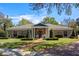 Charming brick home with manicured lawn, brick pathway, and lush landscaping, creating inviting curb appeal at 1600 Barcelona Way, Winter Park, FL 32789