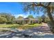 Charming brick home with manicured lawn, brick pathway, and lush landscaping, creating inviting curb appeal at 1600 Barcelona Way, Winter Park, FL 32789