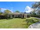Charming brick home with manicured lawn, brick pathway, and lush landscaping, creating inviting curb appeal at 1600 Barcelona Way, Winter Park, FL 32789
