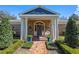 Inviting front porch with brick floor, columns, and a door adorned with a wreath, exuding warmth at 1600 Barcelona Way, Winter Park, FL 32789