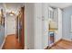 Hallway with hardwood floors, a sliding barn door, and built-in white cabinets at 1600 Barcelona Way, Winter Park, FL 32789