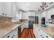 Modern kitchen with granite countertops, stainless steel appliances, and white cabinetry at 1600 Barcelona Way, Winter Park, FL 32789