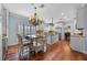 Bright kitchen with hardwood floors, white cabinetry, granite countertops, and stainless steel appliances at 1600 Barcelona Way, Winter Park, FL 32789