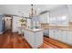 Stylish kitchen with white cabinetry, granite counters, an island, and stainless steel appliances at 1600 Barcelona Way, Winter Park, FL 32789
