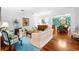 Inviting living room with hardwood floors, comfortable seating, and an open view to a formal dining area at 1600 Barcelona Way, Winter Park, FL 32789