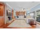Spacious living room featuring a brick fireplace, custom built-ins, and an inviting seating area with hardwood floors at 1600 Barcelona Way, Winter Park, FL 32789