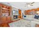 Bright and airy living room with a cozy fireplace, custom shelving, and hardwood floors for a comfortable living space at 1600 Barcelona Way, Winter Park, FL 32789