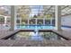 Beautiful pool area with screened enclosure, brick accents and reflection pool at 1600 Barcelona Way, Winter Park, FL 32789
