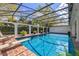Beautiful pool with screened enclosure, surrounded by lush landscaping at 1600 Barcelona Way, Winter Park, FL 32789