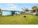 A well-maintained backyard featuring a covered patio, lawn, and privacy fence at 19624 E Umatilla Blvd, Umatilla, FL 32784