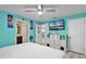 Bedroom featuring a television set, an accent wall, and a white bed at 19624 E Umatilla Blvd, Umatilla, FL 32784