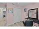 Charming pink bedroom featuring a black vanity and a spacious closet at 19624 E Umatilla Blvd, Umatilla, FL 32784