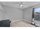 Bedroom featuring an electric fan, a cat tree, and laminate flooring at 19624 E Umatilla Blvd, Umatilla, FL 32784